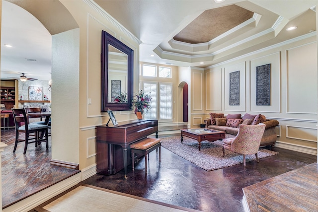 interior space with arched walkways, a tray ceiling, crown molding, and a decorative wall