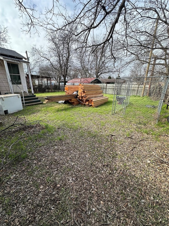 view of yard featuring entry steps and fence