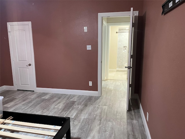 unfurnished room with baseboards and wood finished floors