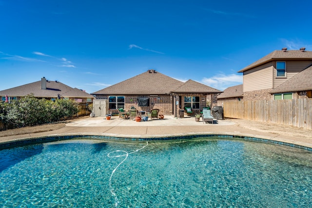 view of swimming pool with a fenced in pool, a patio area, and a fenced backyard