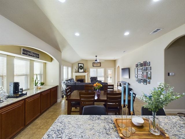 dining area with a fireplace, recessed lighting, visible vents, light tile patterned flooring, and baseboards