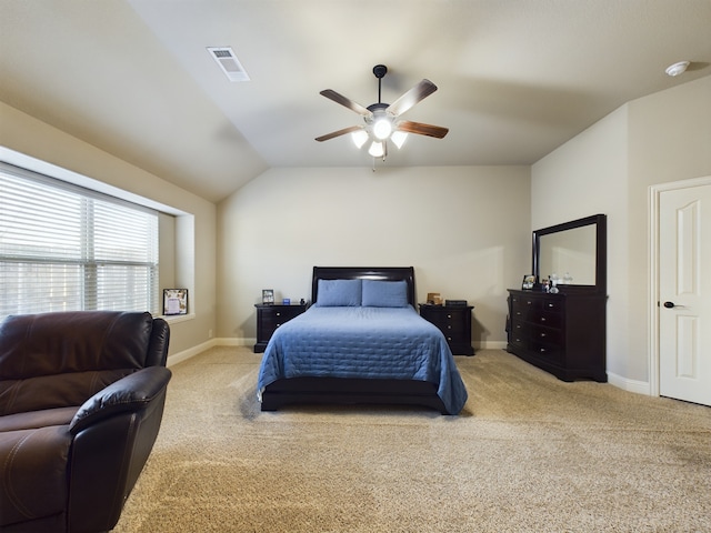 bedroom with lofted ceiling, baseboards, visible vents, and carpet flooring