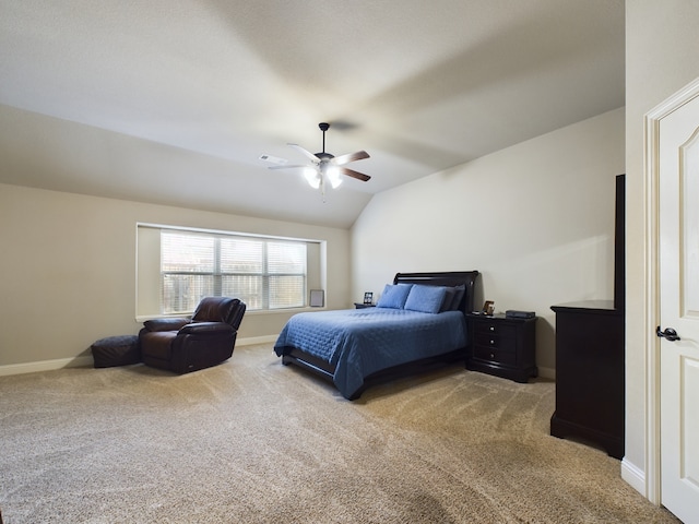 carpeted bedroom featuring lofted ceiling, baseboards, visible vents, and a ceiling fan