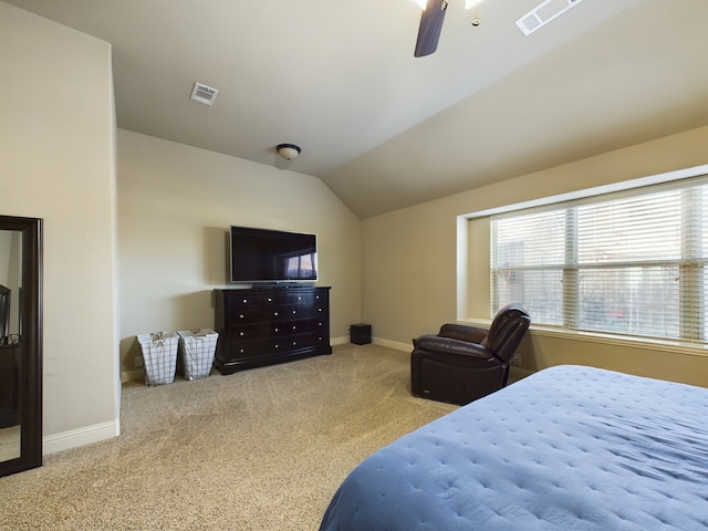 bedroom with lofted ceiling, baseboards, light carpet, and visible vents