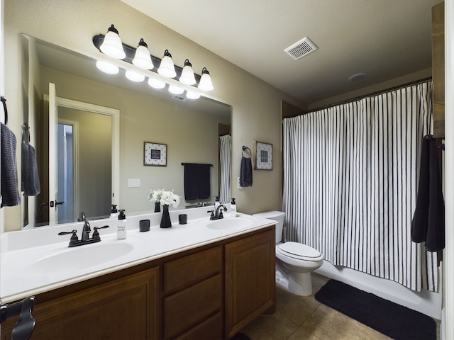 bathroom featuring double vanity, tile patterned flooring, a sink, and visible vents