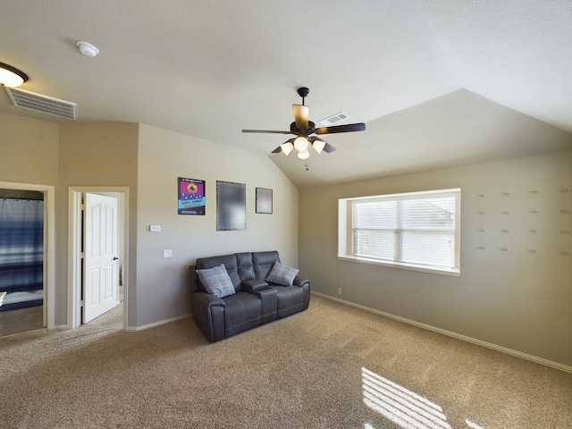 living area featuring vaulted ceiling, baseboards, visible vents, and light colored carpet