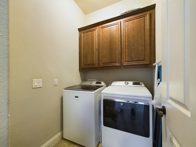 laundry room with a textured wall, cabinet space, independent washer and dryer, and baseboards