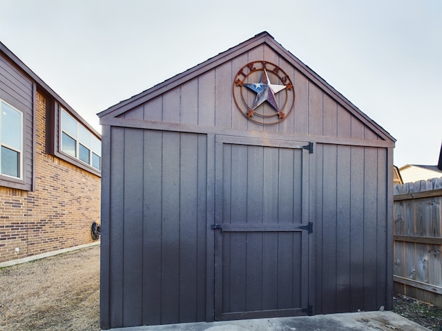 view of shed featuring fence