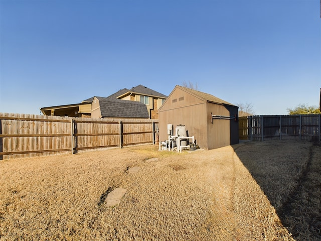 view of yard featuring a fenced backyard and an outdoor structure