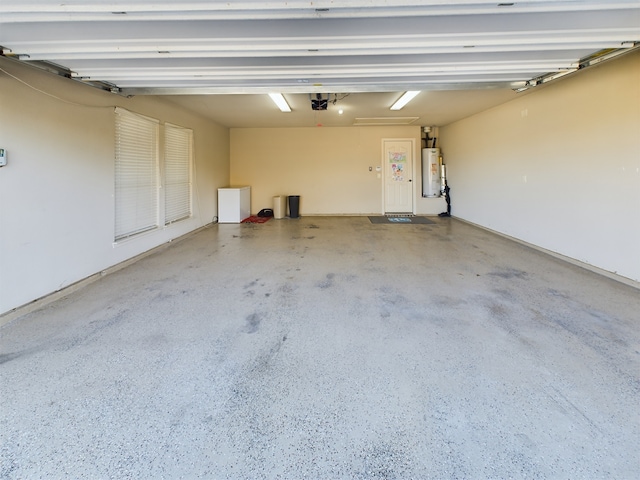 garage with water heater and a garage door opener