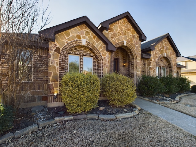 view of front of house with stone siding and brick siding