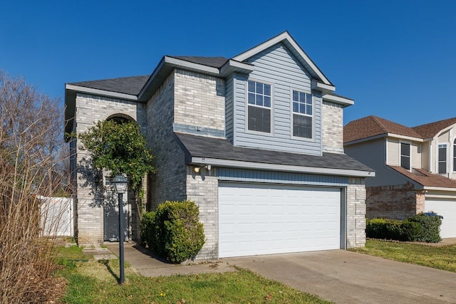 traditional-style house featuring a garage and brick siding