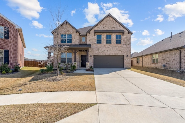 view of front of house featuring a garage, driveway, brick siding, and fence