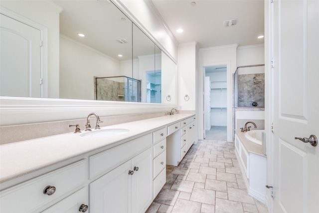 full bathroom featuring double vanity, a stall shower, ornamental molding, and a sink