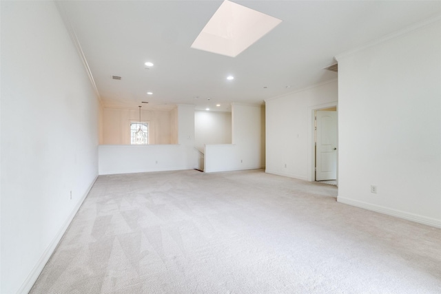 unfurnished room with recessed lighting, light carpet, a skylight, baseboards, and ornamental molding