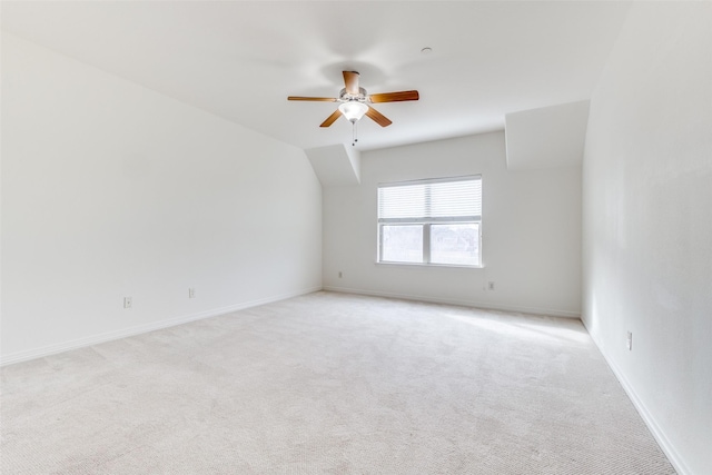 unfurnished room with light colored carpet, ceiling fan, and baseboards