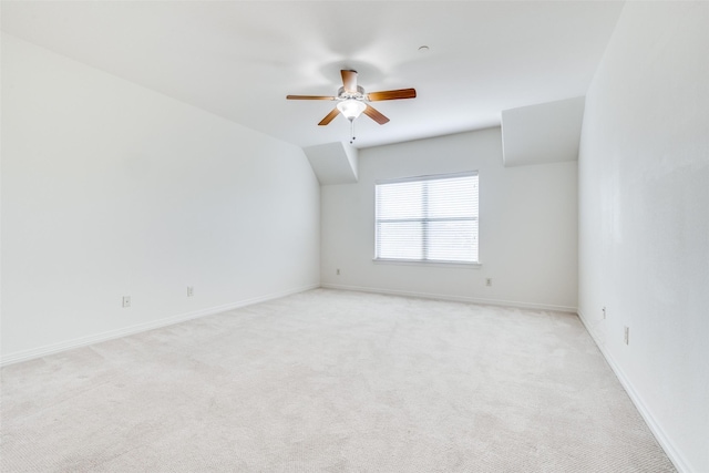 empty room featuring light carpet, baseboards, and a ceiling fan