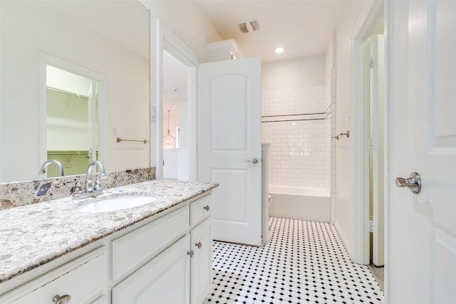 bathroom with shower / bathing tub combination, vanity, and recessed lighting