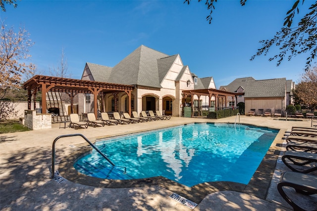 community pool with a patio area, fence, and a pergola