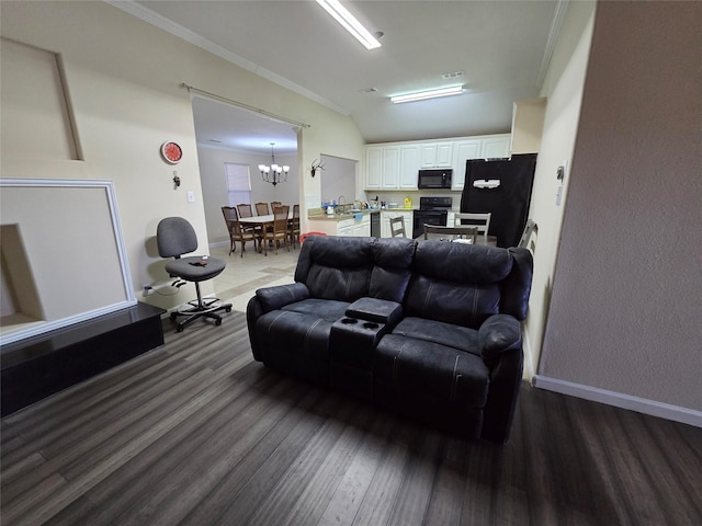 living room with lofted ceiling, a chandelier, baseboards, ornamental molding, and dark wood finished floors