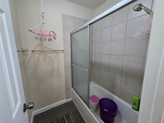 full bath featuring bath / shower combo with glass door