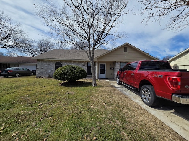 ranch-style house with an attached garage, a front lawn, and brick siding