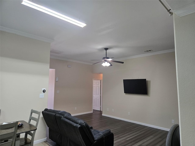 living room featuring crown molding, visible vents, dark wood-type flooring, a ceiling fan, and baseboards