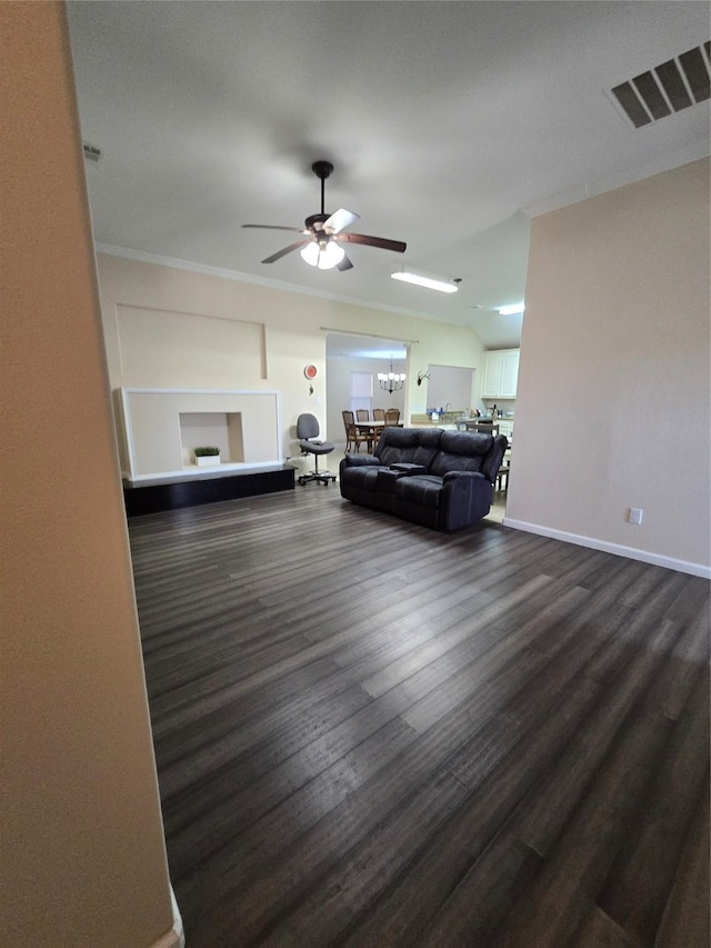 unfurnished living room with baseboards, visible vents, dark wood-type flooring, and ornamental molding