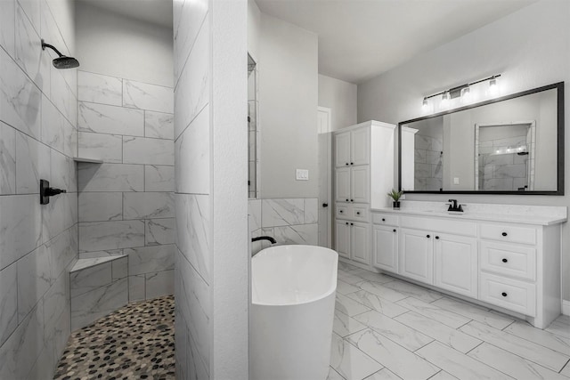 bathroom featuring a freestanding tub, vanity, tile walls, marble finish floor, and tiled shower