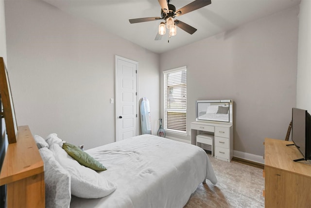 bedroom featuring ceiling fan and baseboards