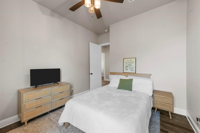 bedroom featuring ceiling fan, baseboards, and wood finished floors