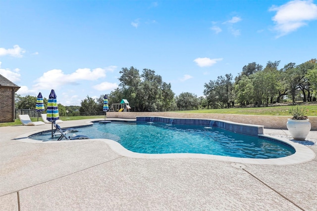 pool featuring a patio area, a playground, and fence