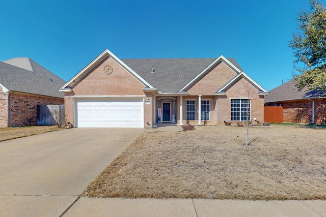 ranch-style house featuring a garage, fence, concrete driveway, and brick siding