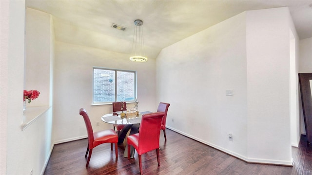 dining area with dark wood-type flooring, visible vents, and baseboards