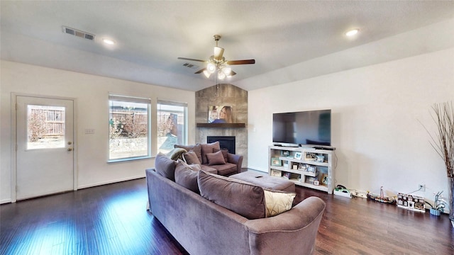 living area featuring dark wood-style floors, a fireplace, visible vents, and a ceiling fan