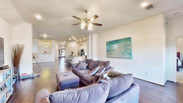 living area with dark wood-style flooring, recessed lighting, visible vents, ceiling fan, and baseboards