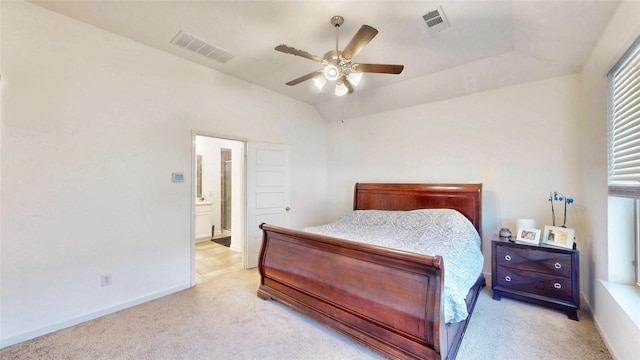 bedroom with vaulted ceiling, baseboards, visible vents, and light colored carpet