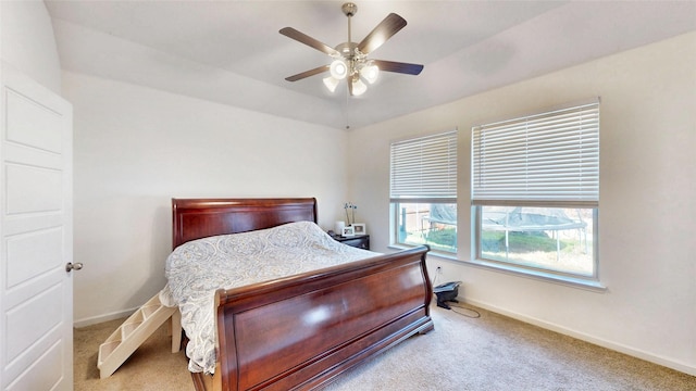 bedroom featuring ceiling fan, baseboards, and light colored carpet