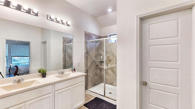 ensuite bathroom featuring connected bathroom, a sink, and a shower stall