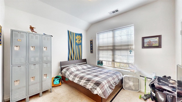 bedroom with carpet, visible vents, and lofted ceiling
