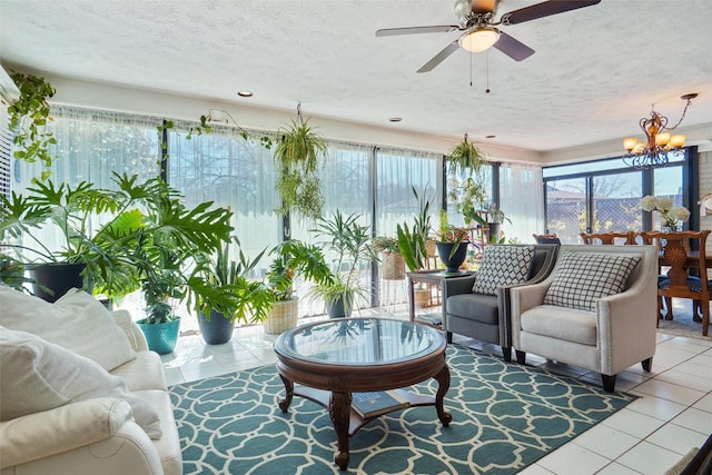 sunroom / solarium featuring ceiling fan with notable chandelier