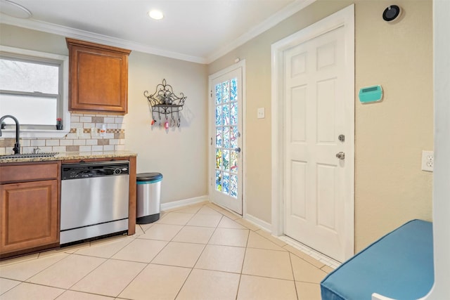 kitchen with decorative backsplash, ornamental molding, stainless steel dishwasher, a sink, and light tile patterned flooring