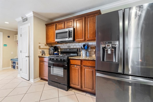 kitchen featuring light tile patterned floors, visible vents, appliances with stainless steel finishes, backsplash, and light stone countertops