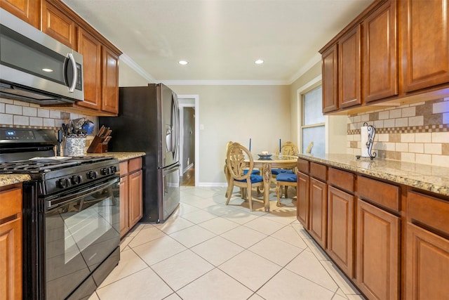 kitchen with ornamental molding, stainless steel appliances, light stone counters, and brown cabinets