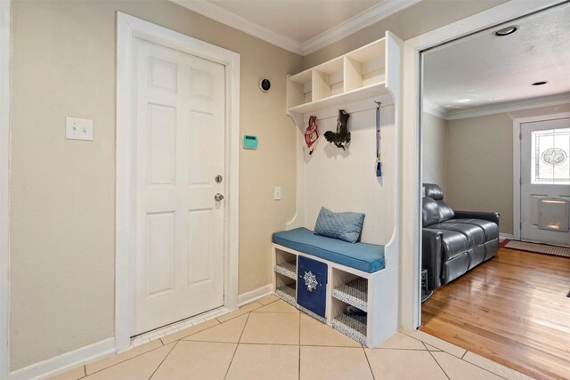 mudroom featuring baseboards, tile patterned floors, and crown molding