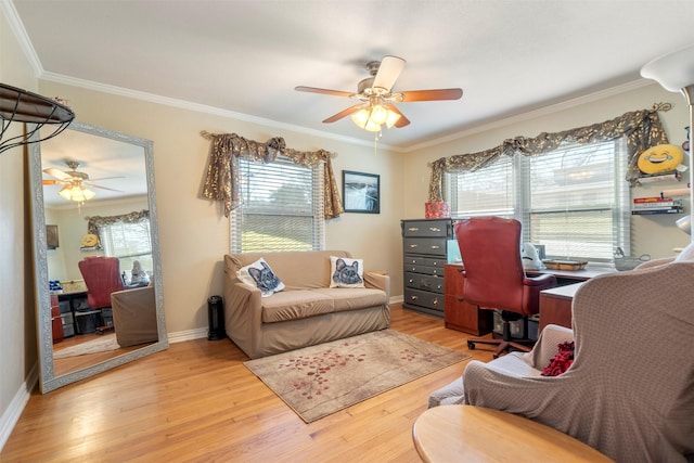 home office with light wood-style floors, baseboards, ornamental molding, and a ceiling fan