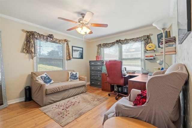 home office with ornamental molding, light wood-style flooring, baseboards, and a ceiling fan