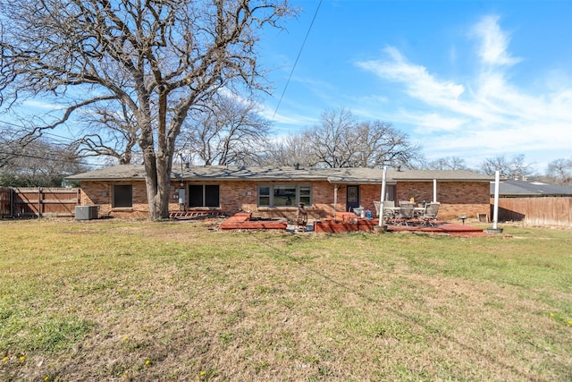 back of house featuring brick siding, a patio area, fence, and a yard