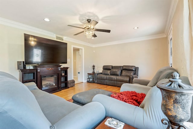 living area featuring visible vents, a ceiling fan, wood finished floors, crown molding, and recessed lighting