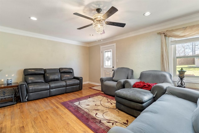 living room with ceiling fan, recessed lighting, baseboards, ornamental molding, and light wood-type flooring